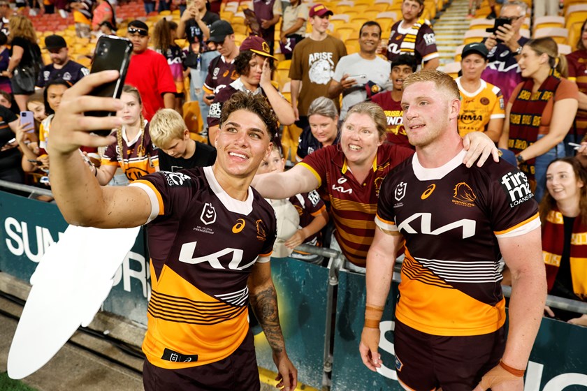 Reece Walsh and Thomas Flegler with Brisbane Broncos fans. 