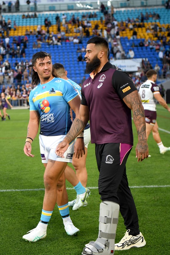 Payne Haas with brother Klese Haas after injuring his foot in Round 22 against the Titans.