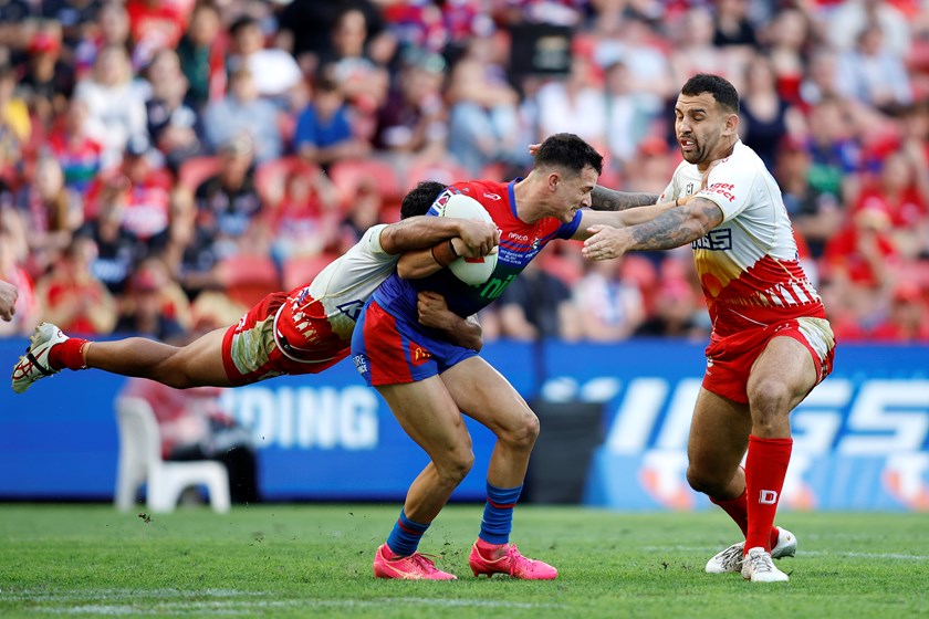 David Armstrong tries to evade Josh Kerr and Trai Fuller.