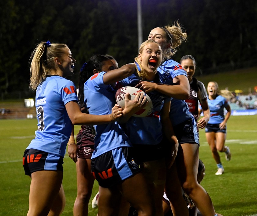 Kasey Reh celebrates a try in Thursday night's victory over Queensland.