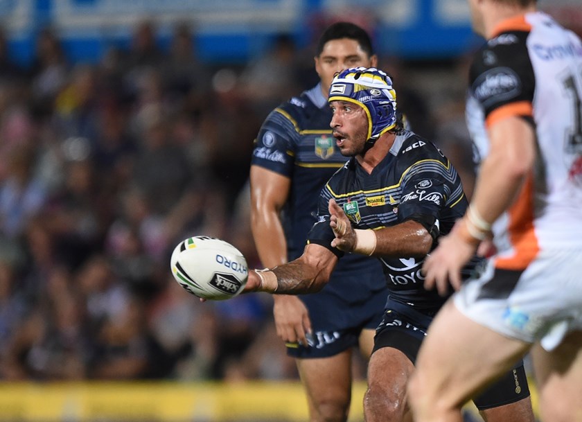 Johnathan Thurston gets a pass away against Wests Tigers.