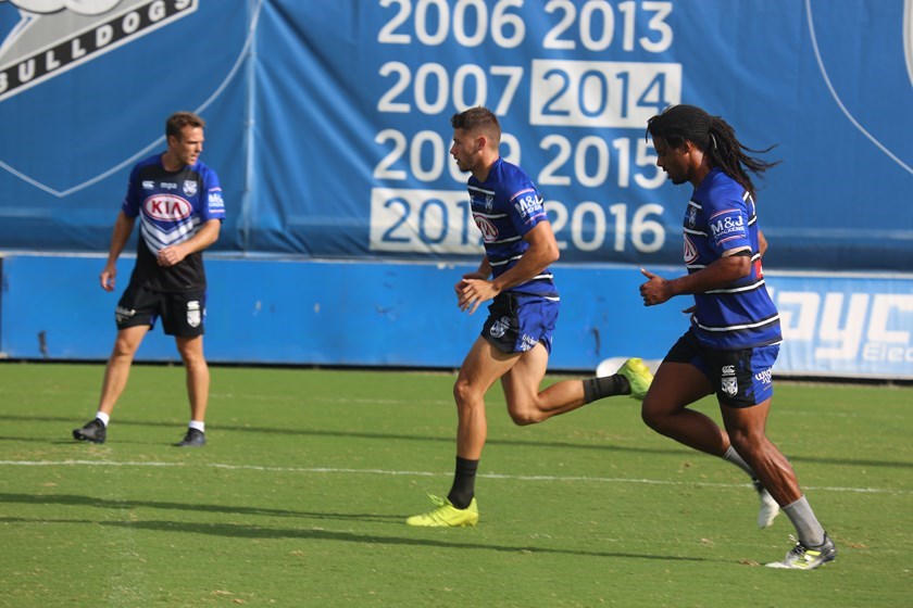 Former Olympic sprinter Matt Shirvington (left) taking the Dogs through their paces.