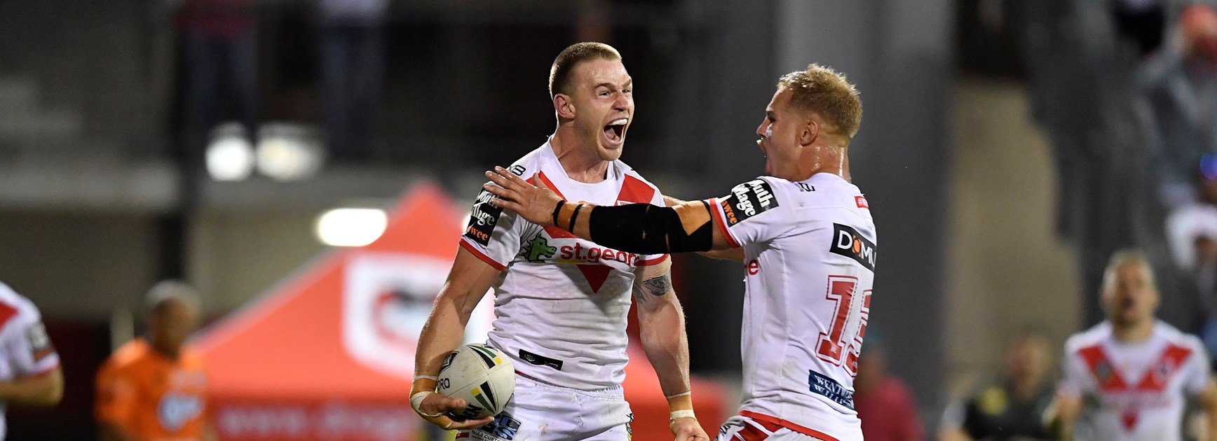 Euan Aitken celebrates a try with Jack de Belin.