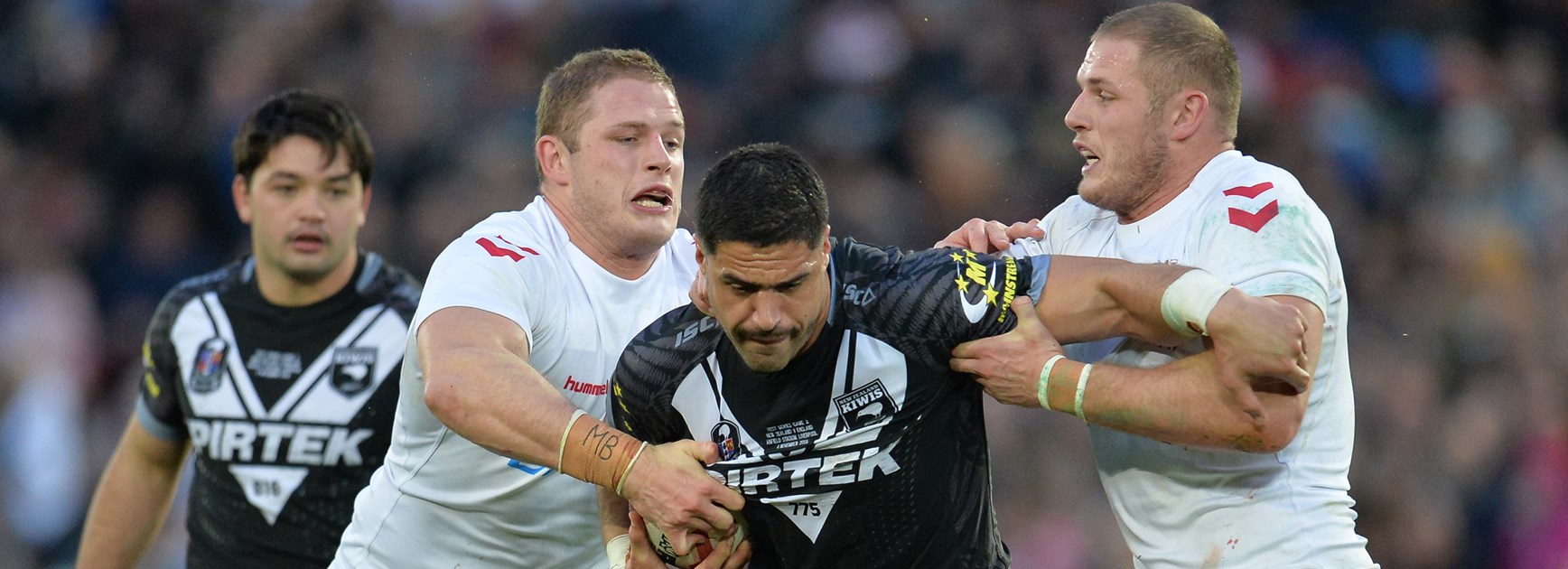 Jesse Bromwich is wrapped up by Tom and George Burgess at Anfield.