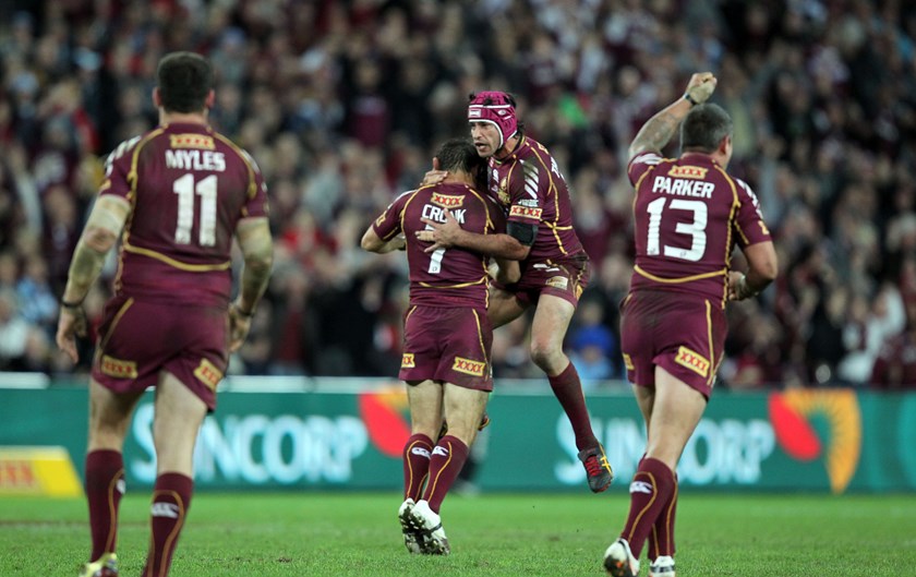 Cooper Cronk gets a hug from Johnathan Thurston after a match-winning field goal for the Maroons in 2012.
