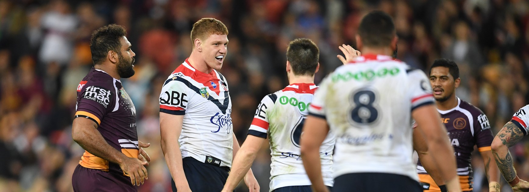 Broncos forward Sam Thaiday (left) ready to confront Roosters prop Dylan Napa.