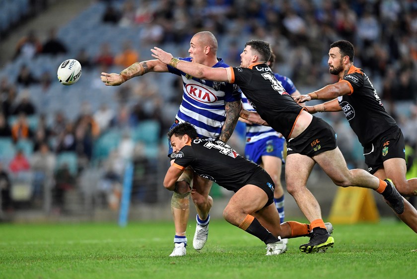 David Klemmer offloads for the Bulldogs.