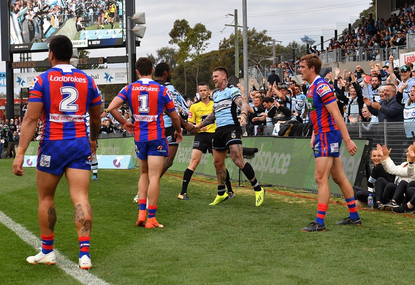 Josh Dugan celebrates a try for the Sharks.