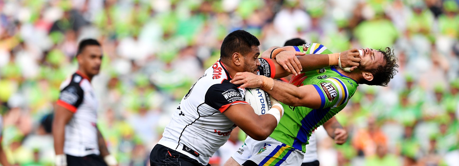 New Zealand Warriors prop Sam Lisone palming off Aidan Sezer. 