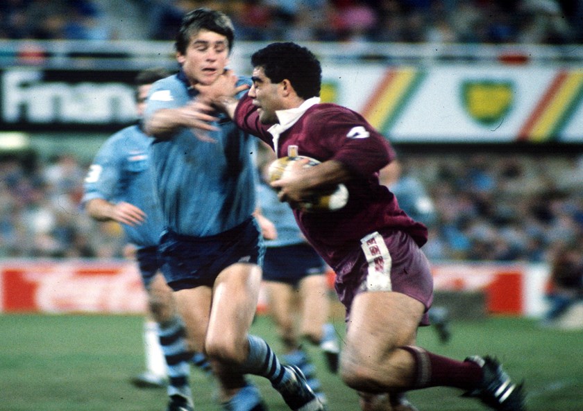 Queensland's Mal Meninga keeps opposing centre Chris Mortimer at arm's length.