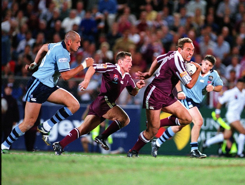 Gorden Tallis tears away from Michael Vella.