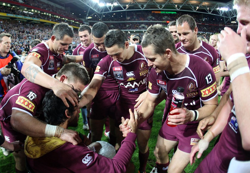 A wheelchair-bound Johnathan Thurston joins the celebrations for Darren Lockyer in 2011